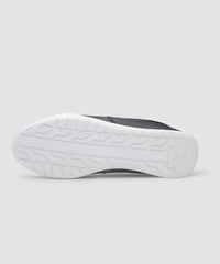 Bottom view of black AKIN driving shoe for car enthusiasts. 